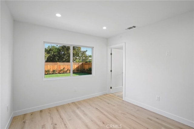 empty room with light hardwood / wood-style flooring