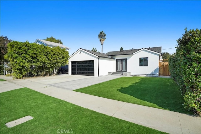 view of front of home featuring a front yard and a garage