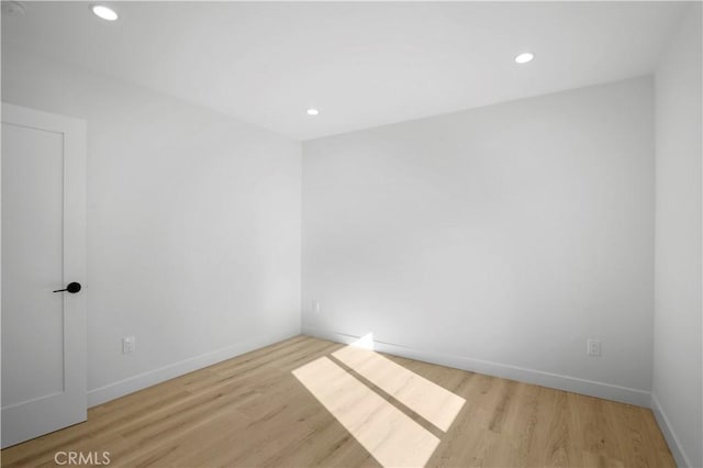 empty room with light hardwood / wood-style flooring