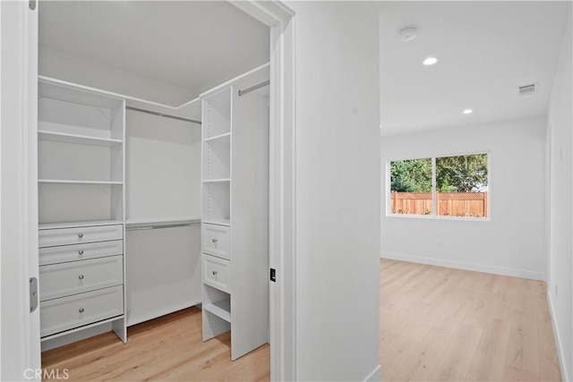 spacious closet featuring light hardwood / wood-style flooring