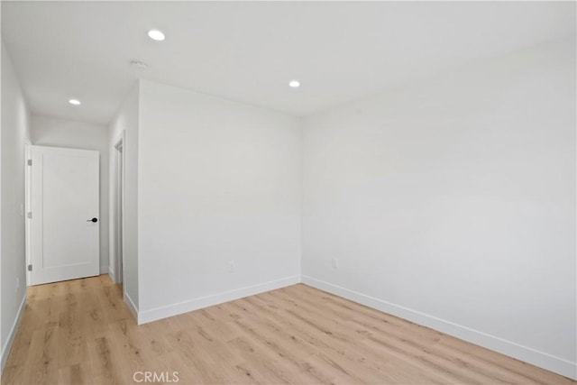 unfurnished room with light hardwood / wood-style flooring