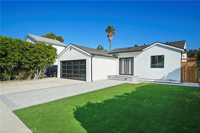 single story home featuring a garage and a front yard