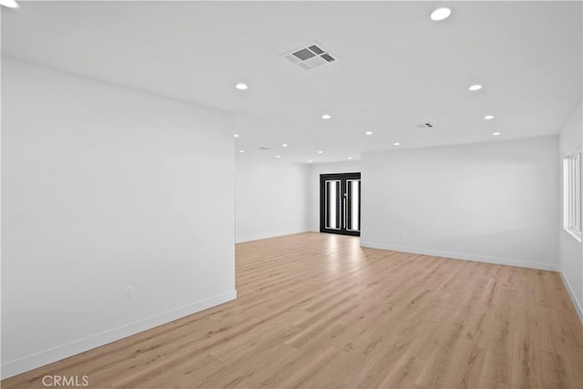 spare room with light hardwood / wood-style flooring