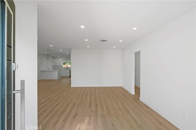 unfurnished living room with light wood-type flooring