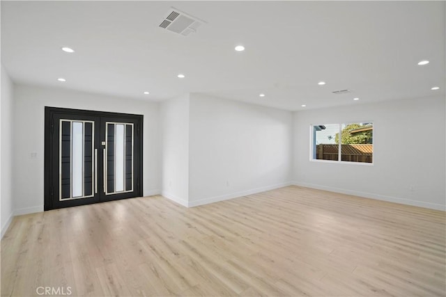 spare room with light hardwood / wood-style floors