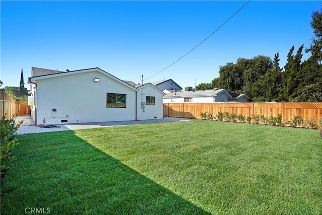 rear view of house with a lawn and a patio area