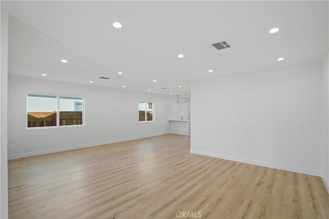 empty room with light hardwood / wood-style flooring