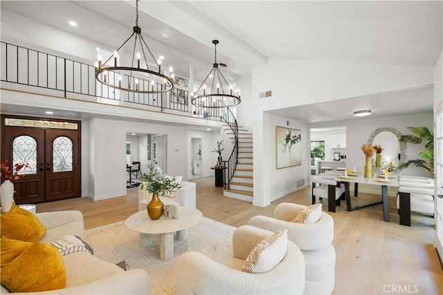 living room with beamed ceiling, french doors, light hardwood / wood-style floors, a notable chandelier, and high vaulted ceiling