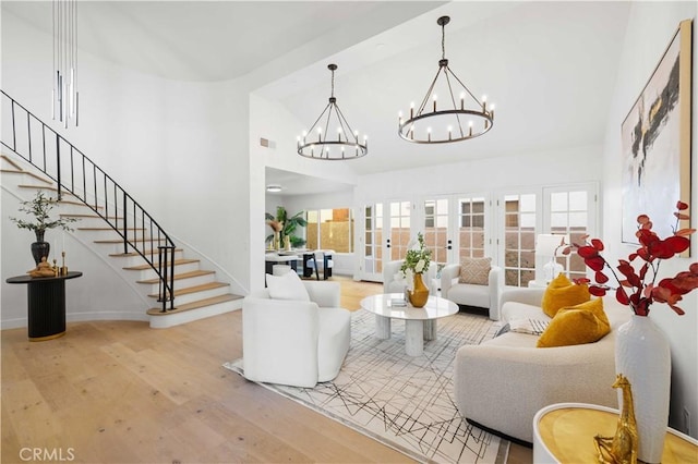 living room featuring hardwood / wood-style flooring, a high ceiling, and french doors