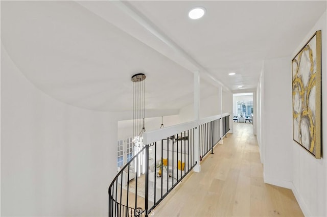 corridor with light hardwood / wood-style floors