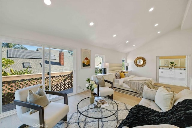 bedroom featuring access to outside, vaulted ceiling, and light hardwood / wood-style floors