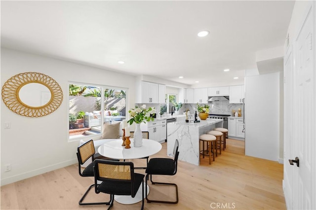 dining space with light hardwood / wood-style floors