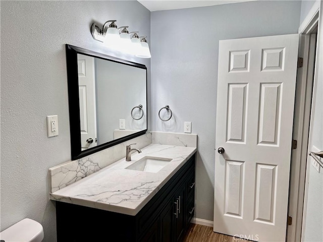 2328 Via Mariposa W Unit B, Laguna Woods, CA 92637 - bathroom featuring toilet, wood finished floors, and vanity