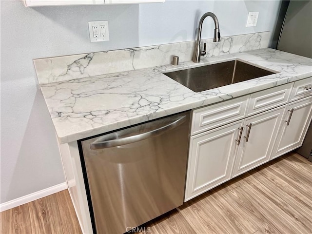 2328 Via Mariposa W Unit B, Laguna Woods, CA 92637 - kitchen with white cabinetry, light stone counters, a sink, light wood finished floors, and dishwasher