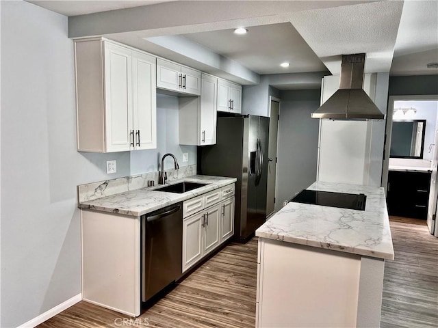 2328 Via Mariposa W Unit B, Laguna Woods, CA 92637 - kitchen featuring appliances with stainless steel finishes, a sink, wall chimney exhaust hood, baseboards, and wood finished floors