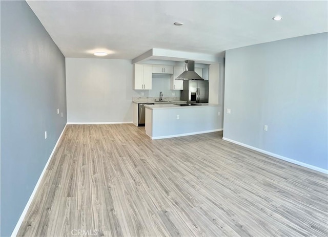 unfurnished living room with sink and light hardwood / wood-style floors