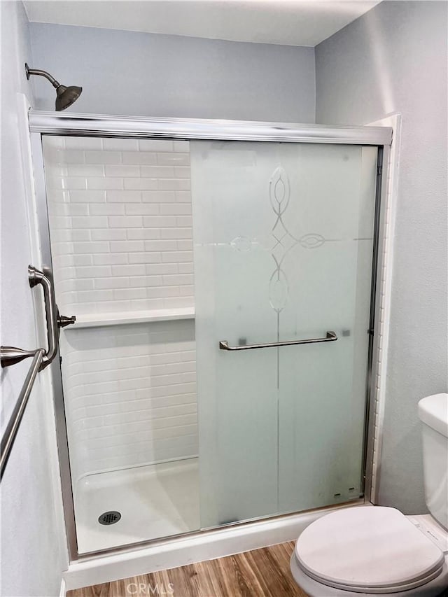 2328 Via Mariposa W Unit B, Laguna Woods, CA 92637 - bathroom with a shower stall, toilet, and wood finished floors