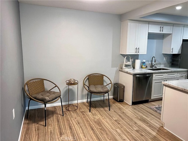 2328 Via Mariposa W Unit B, Laguna Woods, CA 92637 - kitchen featuring stainless steel dishwasher, a sink, light wood-style floors, and baseboards