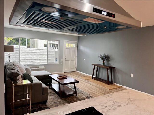 2328 Via Mariposa W Unit B, Laguna Woods, CA 92637 - living room featuring baseboards, a wall mounted air conditioner, and wood finished floors