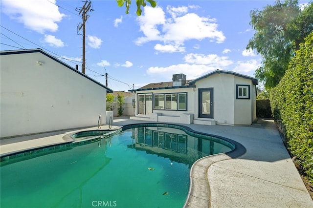 view of pool with an in ground hot tub and a patio