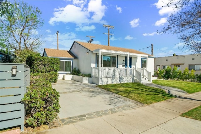 bungalow featuring a porch and a front lawn