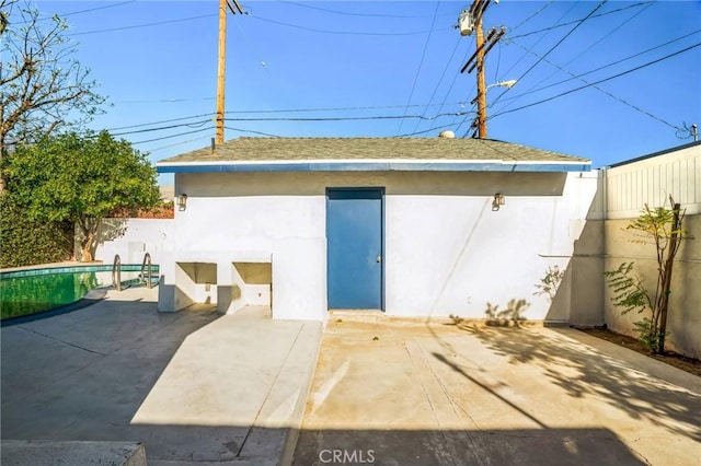 view of outbuilding featuring a fenced in pool