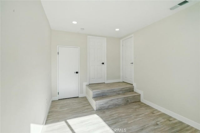 stairs with wood-type flooring