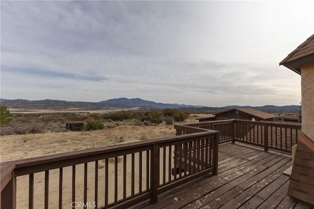 wooden deck with a mountain view