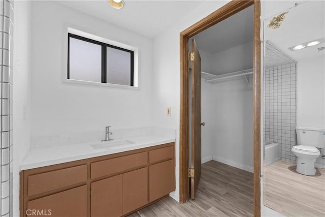 full bathroom featuring hardwood / wood-style flooring, vanity, toilet, and shower / bath combination