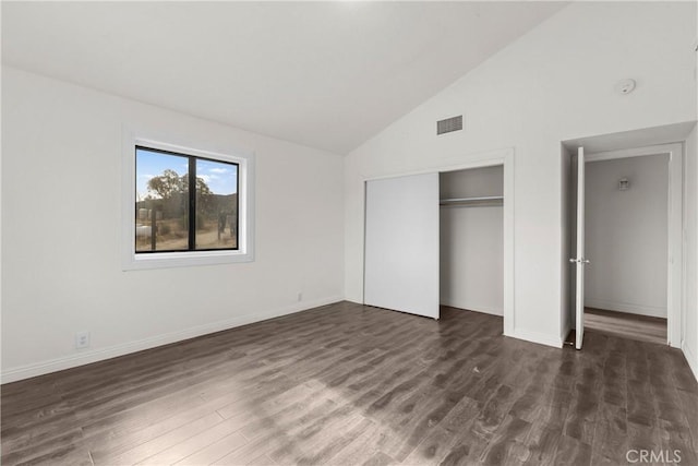 unfurnished bedroom featuring dark hardwood / wood-style floors and vaulted ceiling