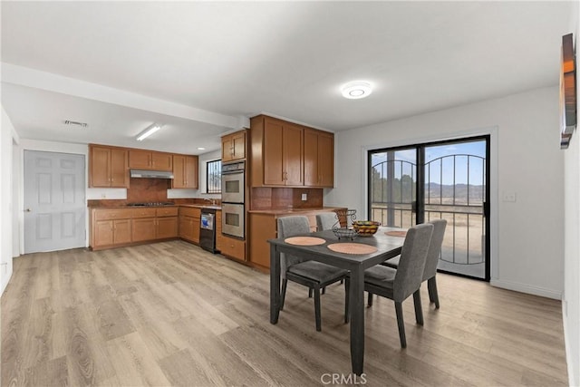 dining space with light hardwood / wood-style floors