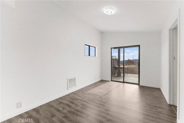 unfurnished room with dark hardwood / wood-style floors and lofted ceiling