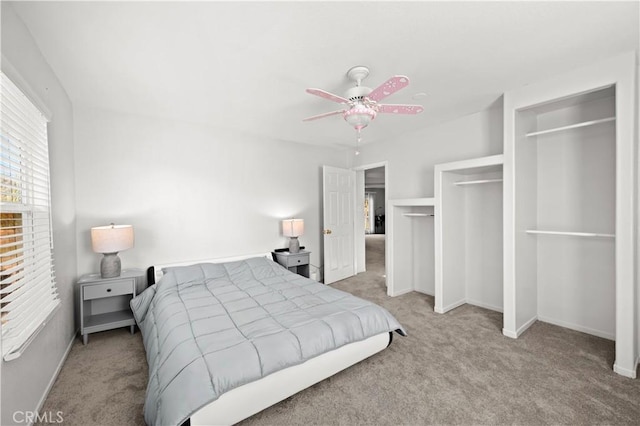 carpeted bedroom featuring ceiling fan and baseboards