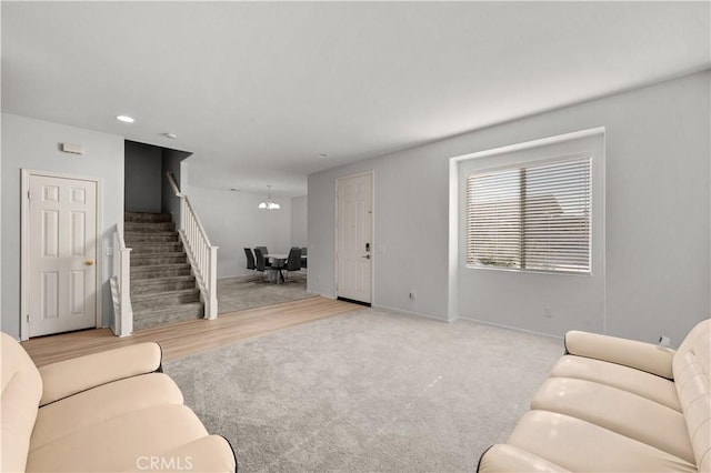 living area with carpet, recessed lighting, stairway, a chandelier, and baseboards