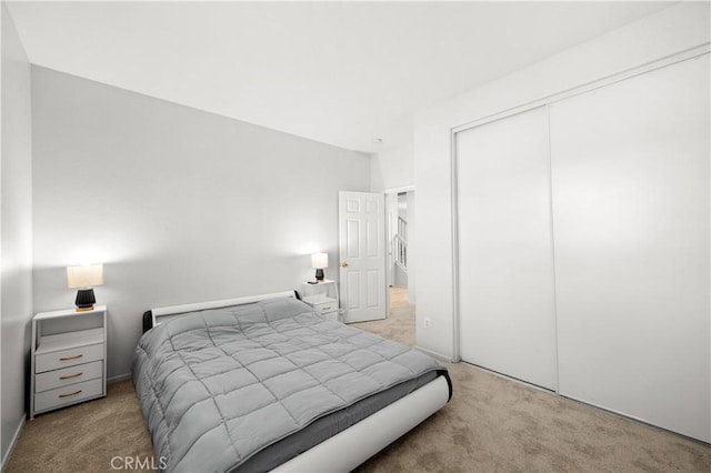 carpeted bedroom featuring a closet