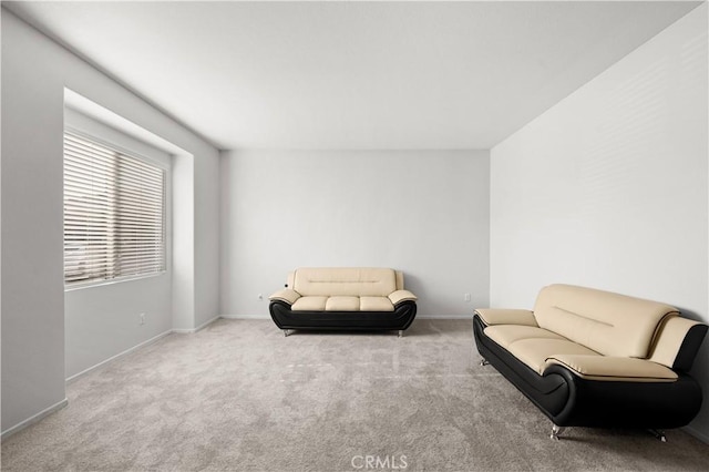 sitting room featuring carpet flooring and baseboards