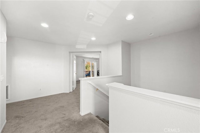 hallway featuring carpet, recessed lighting, visible vents, an upstairs landing, and baseboards