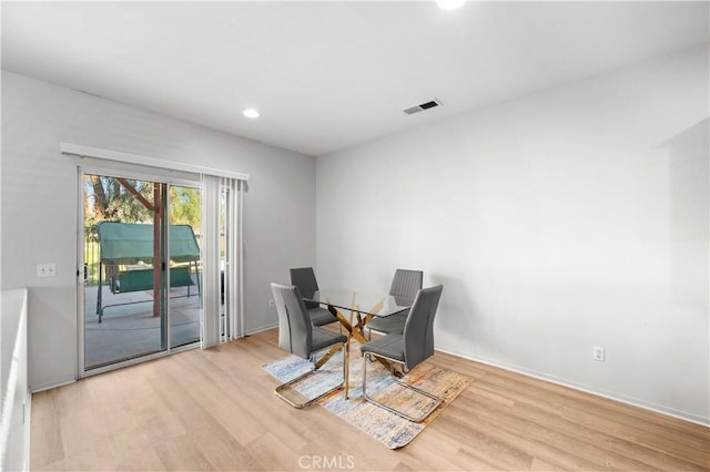 dining area with wood finished floors, visible vents, and recessed lighting