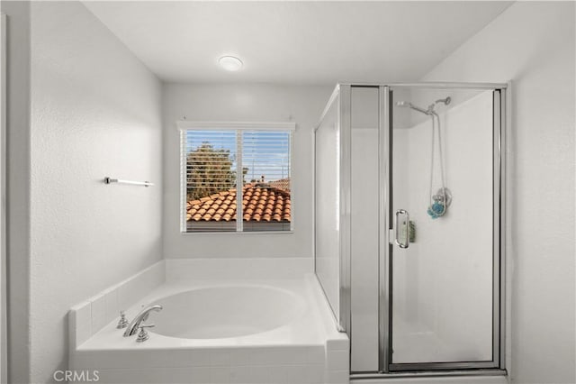 full bath featuring a shower stall and a bath