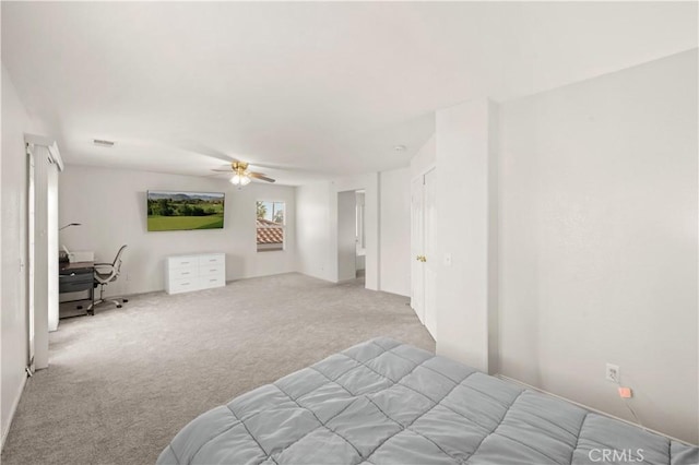 carpeted bedroom with a ceiling fan and visible vents