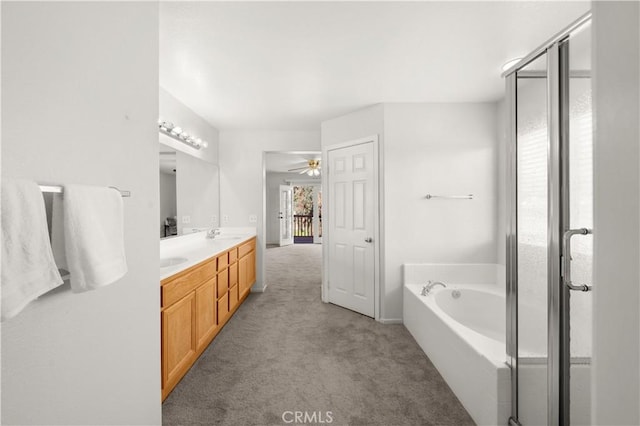 bathroom with a bathing tub, ceiling fan, vanity, and a wealth of natural light