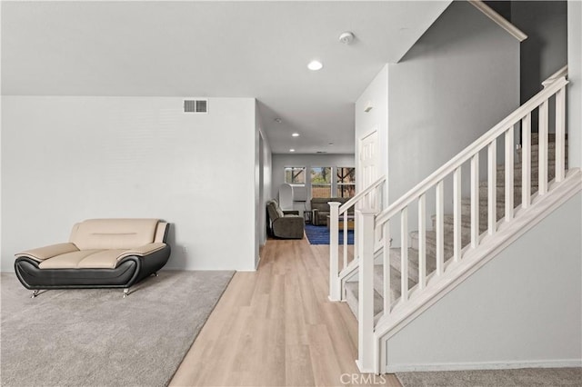 interior space featuring stairs, wood finished floors, visible vents, and recessed lighting