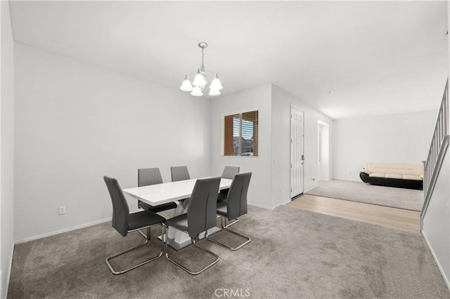 dining area featuring baseboards, carpet, and a notable chandelier