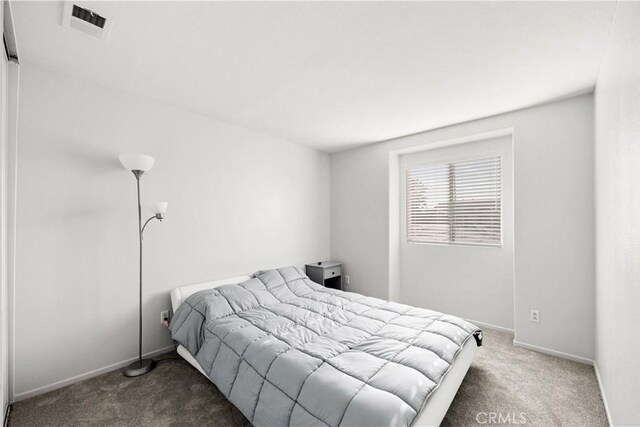 carpeted bedroom featuring visible vents and baseboards