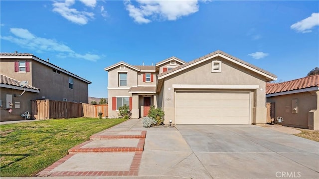 traditional-style home with a garage, concrete driveway, stucco siding, fence, and a front yard