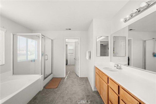 bathroom featuring a bath, a stall shower, vanity, and visible vents