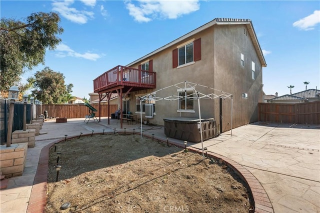 back of house with central air condition unit, a patio area, and a wooden deck