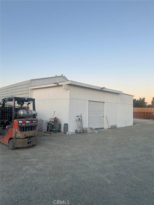 view of garage at dusk