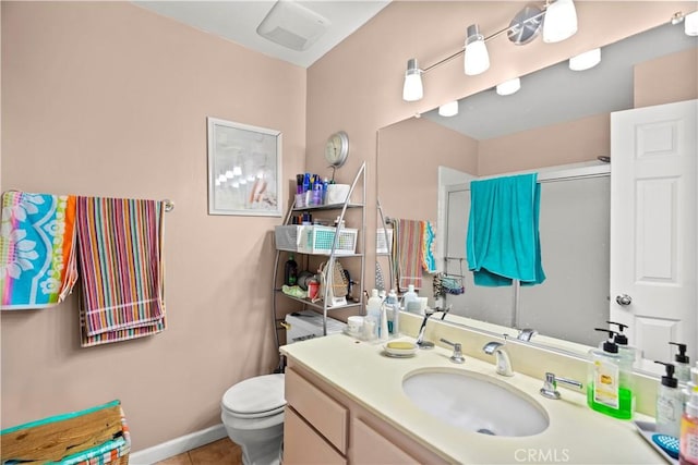 bathroom with tile patterned flooring, vanity, toilet, and a shower with door