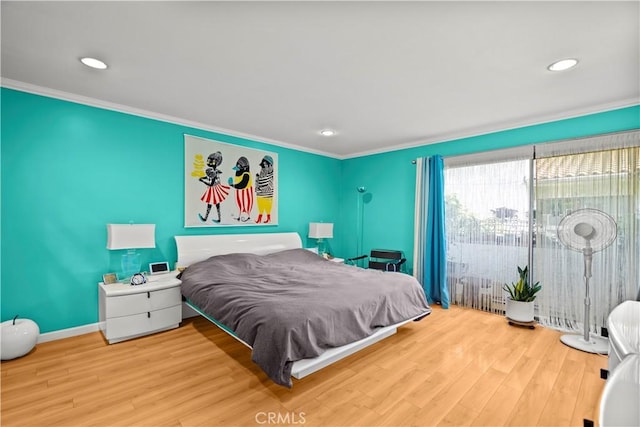 bedroom featuring access to outside, wood-type flooring, and ornamental molding